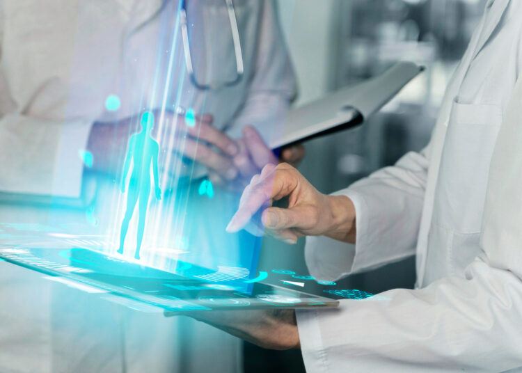 An image showing sciencetist holding a tablet and reports in clinic